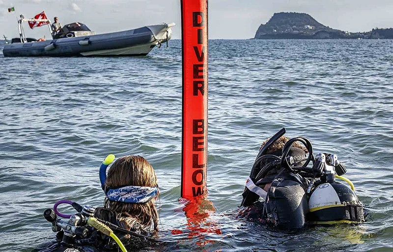Colorful inflatable Diving SMB buoy in orange and fluorescent yellow for scuba diving safety and visibility.